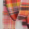 close up detail of a woollen hand-woven scarf in pinks, yellow and black by textile artist Teresa Dunne