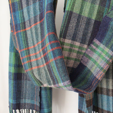 woollen hand-woven scarf in greens, blue and an orange stripe by textile artist Teresa Dunne