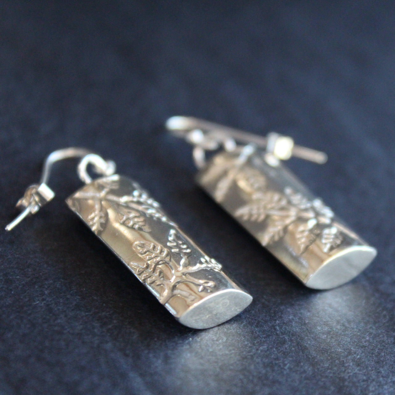Plantae earrings with embossed ash leaves in silver by Beverly Bartlett