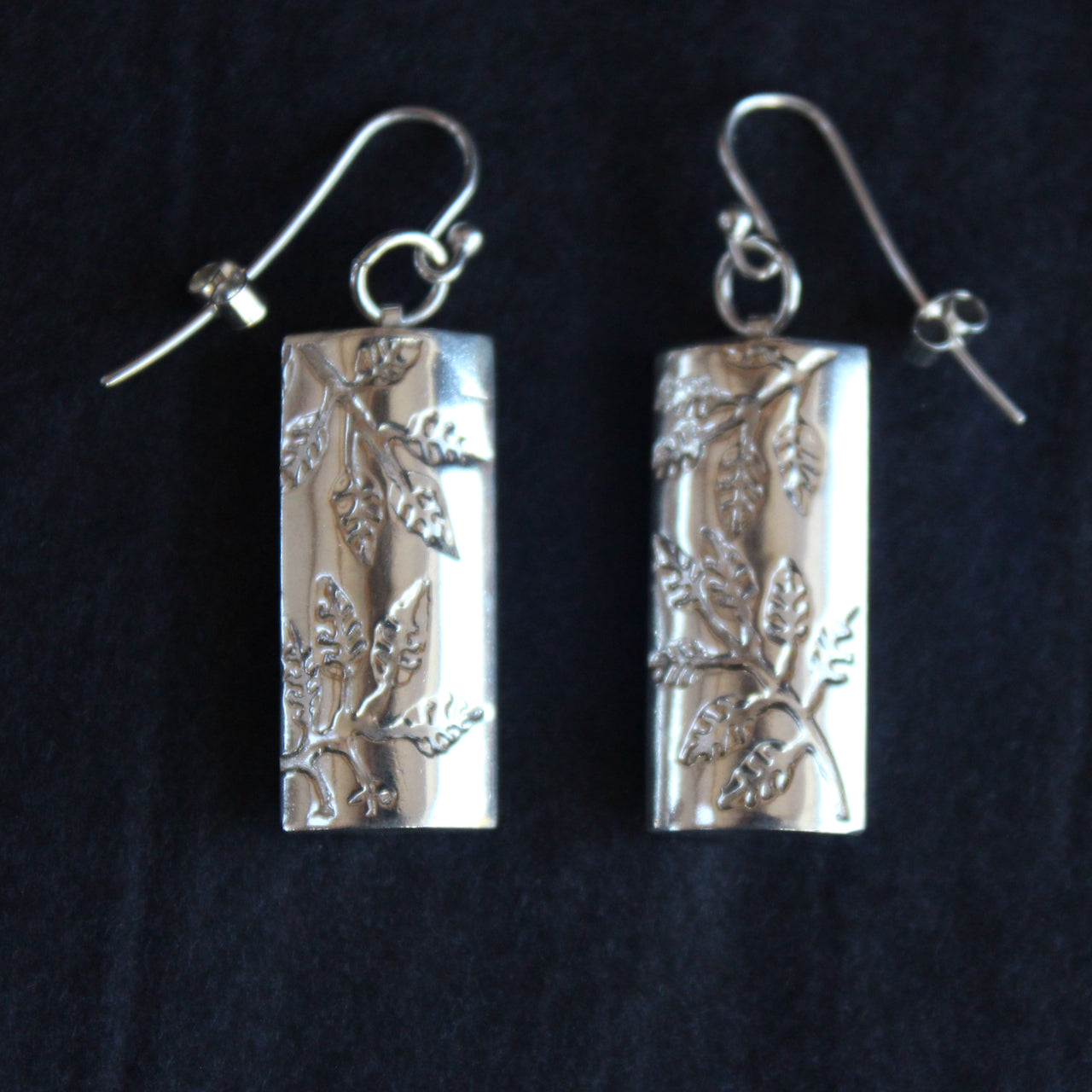 Plantae earrings with embossed ash leaves in silver by Beverly Bartlett