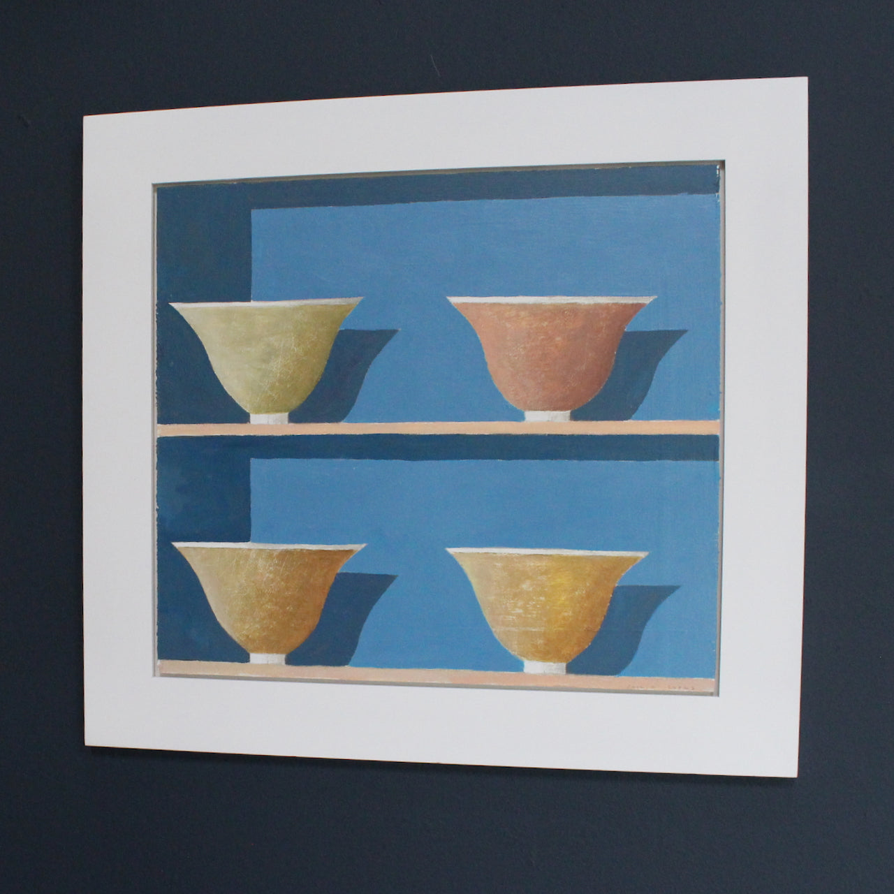 a framed painting of four bowls in yellows and reds on two shelves against a blue wall  it is by Cornish artist Philip Lyons.