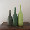 three ceramic bottles in different shades of green and incremental sizes by Lucy Burley ceramicist 