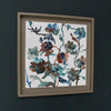 a framed Lucy Innes Williams painting of blue, green and rust coloured flowers it is called Hash Browns 