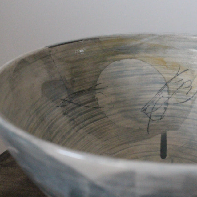close up detail of large ceramic bowl glazed in pale greys and yellows made by UK ceramicist Kate Welton