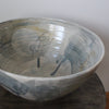 a close up detail of large ceramic bowl glazed in pale greys and yellows made by UK ceramicist Kate Welton.