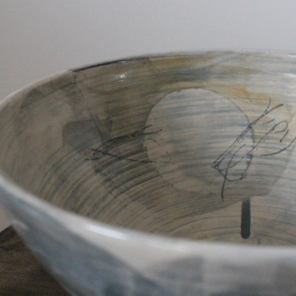 close up detail of large ceramic bowl glazed in pale greys and yellows made by UK ceramicist Kate Welton 