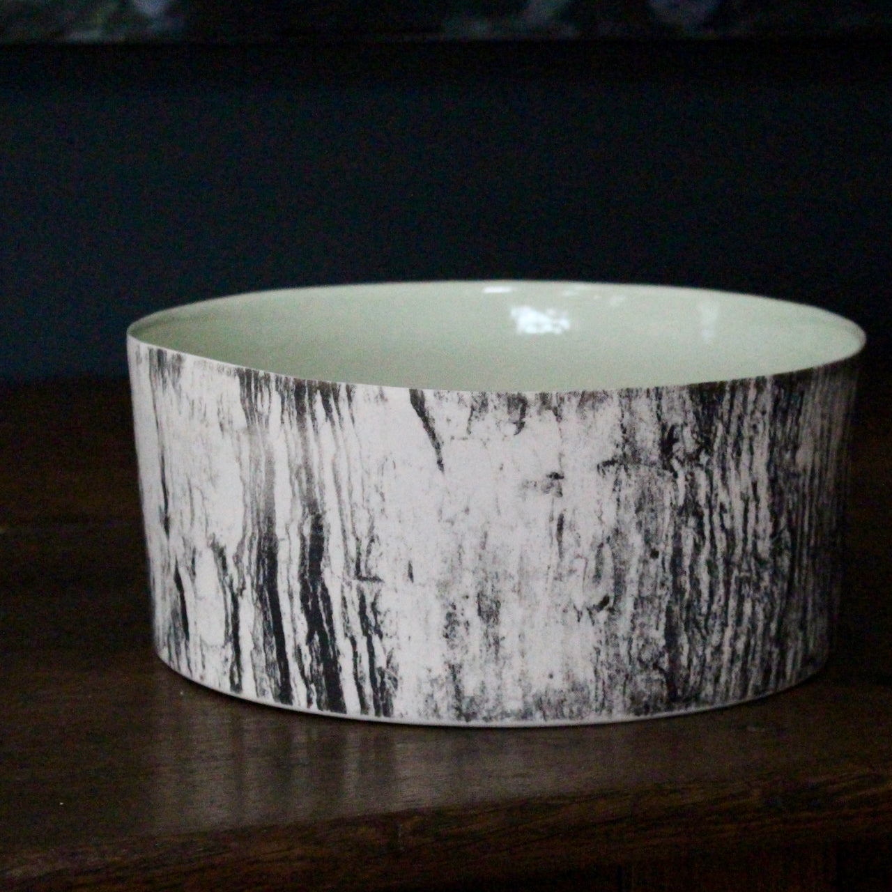 ceramic bowl with a green interior glaze and a black and white tree bark effect on exterior by UK ceramicist Heidi Harrington