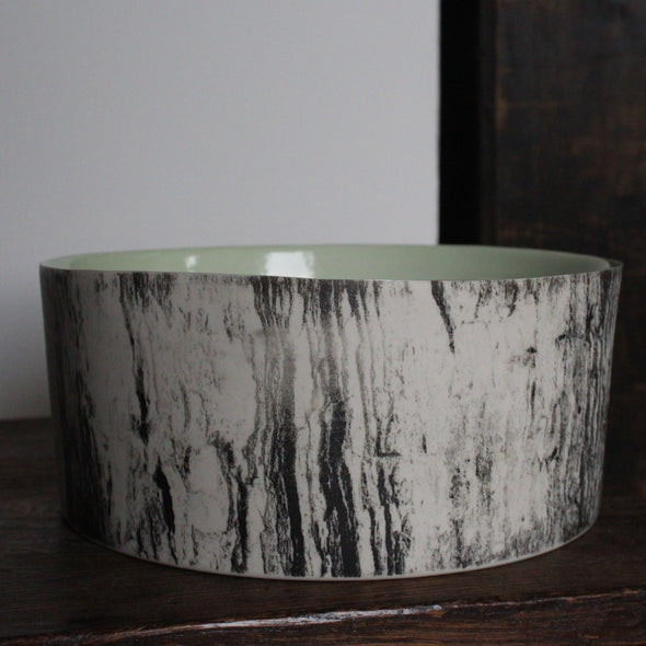 ceramic bowl with a green interior glaze and a black and white tree bark effect on exterior by Heidi Harrington, UK ceramicist 