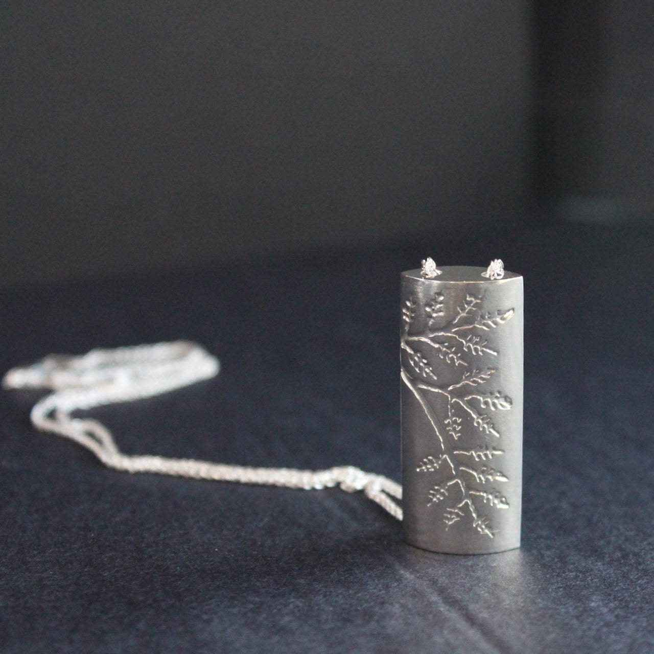 Plantae pendant embossed with ash leaves in silver by Beverly Bartlett