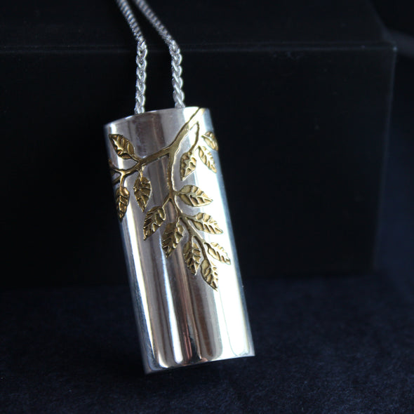 Plantae pendant with gold ash leaves in silver by Beverly Barlett