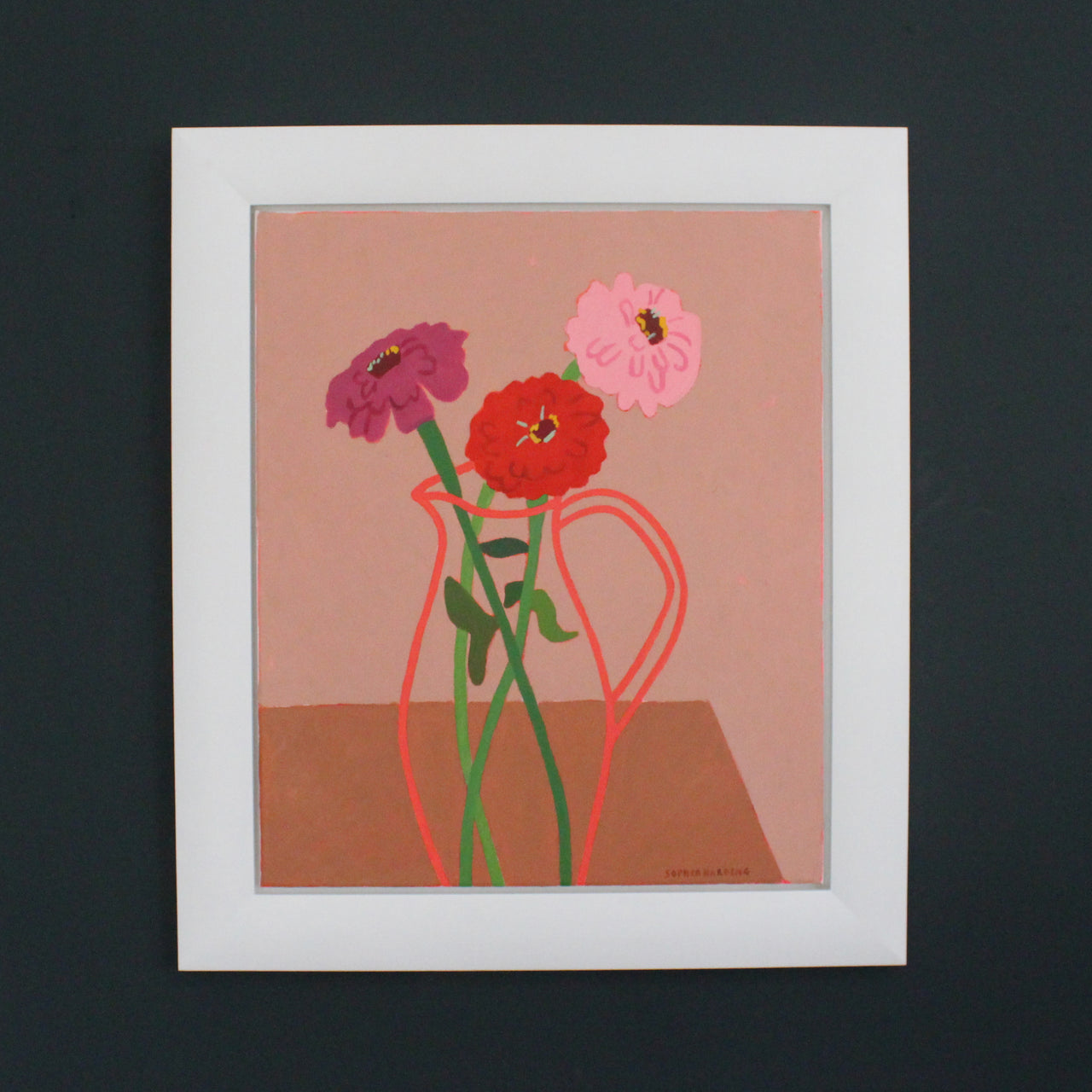 framed Sophie Harding painting called  Penzance Zinnias 3 Pink Flowers in clear vase on wooden table