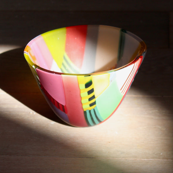 a Ruth Shelley multicoloured glass bowl in pinks, red and greens 