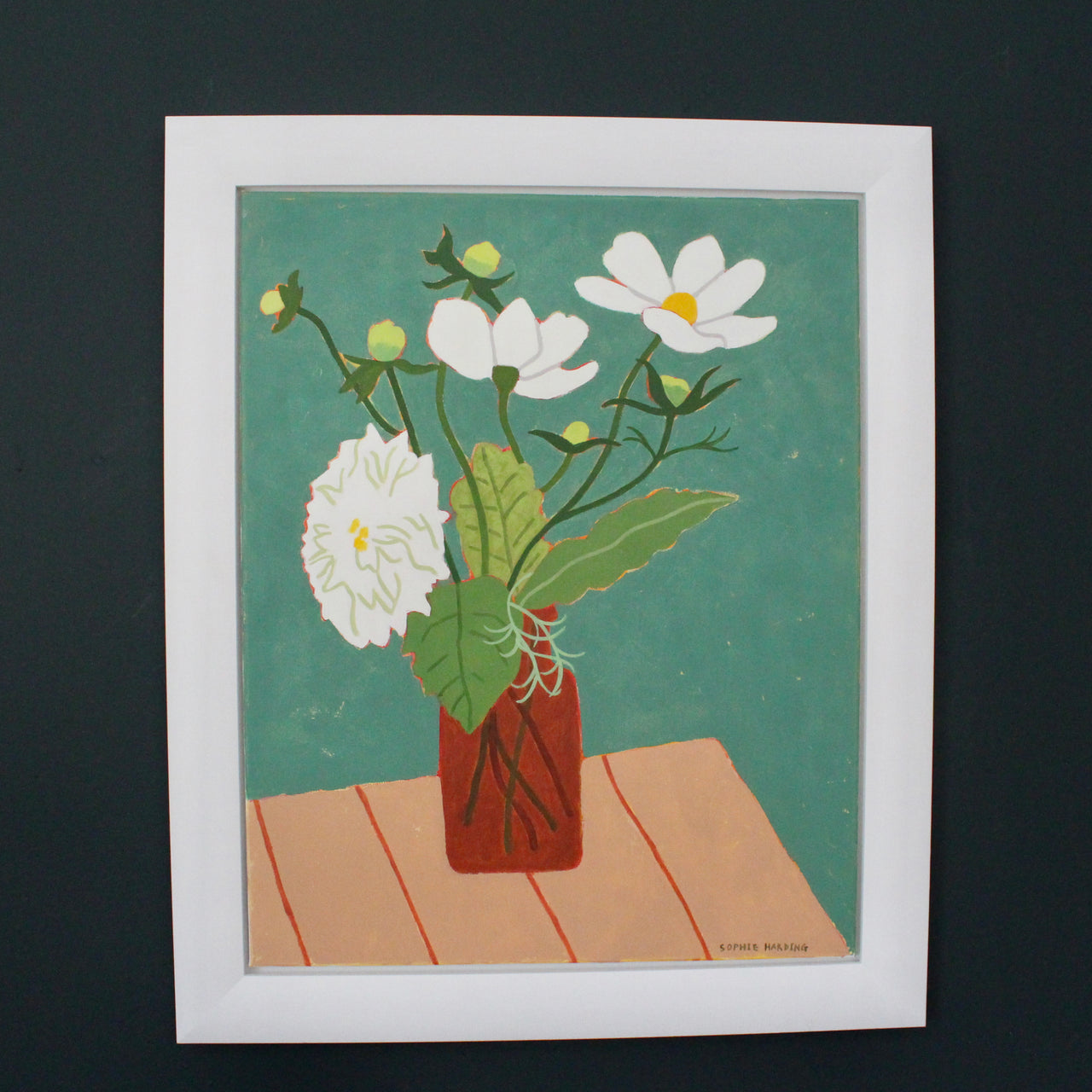 a framed a painting by artist Sophie Harding of white flowers on a wooden table with a green background 